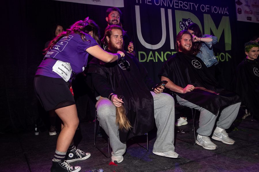 Landon (left) and Levi Paulsen (right) get a trim during Dance Marathon 25 at the Iowa Memorial Union on Saturday, February 2, 2019. After Landon's girlfriend Alexis Henry raised over $10,000 for the Big Event, the twins committed to losing their locks.