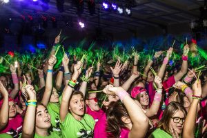 Dancers wave their glow sticks during Power Hour at Dance Marathon 25 at the IMU on Feb. 2.