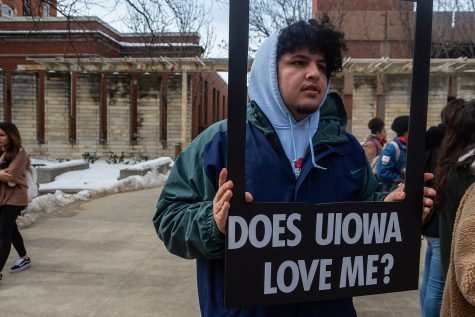UI Student Chris Vazquez holds a picture frame during a rally for the #DoesUIowaLoveMe movement in the T. Anne Cleary Walkway on Thursday, February 28, 2019. Students, university faculty, and community members gathered to tell their stories about belonging to marginalized cultural groups. Does UIowa Love Me is a collective of students that aims to give underrepresented students an outlet to share their experiences as people of color at a predominantly white institution. (Wyatt Dlouhy/The Daiy Iowan)