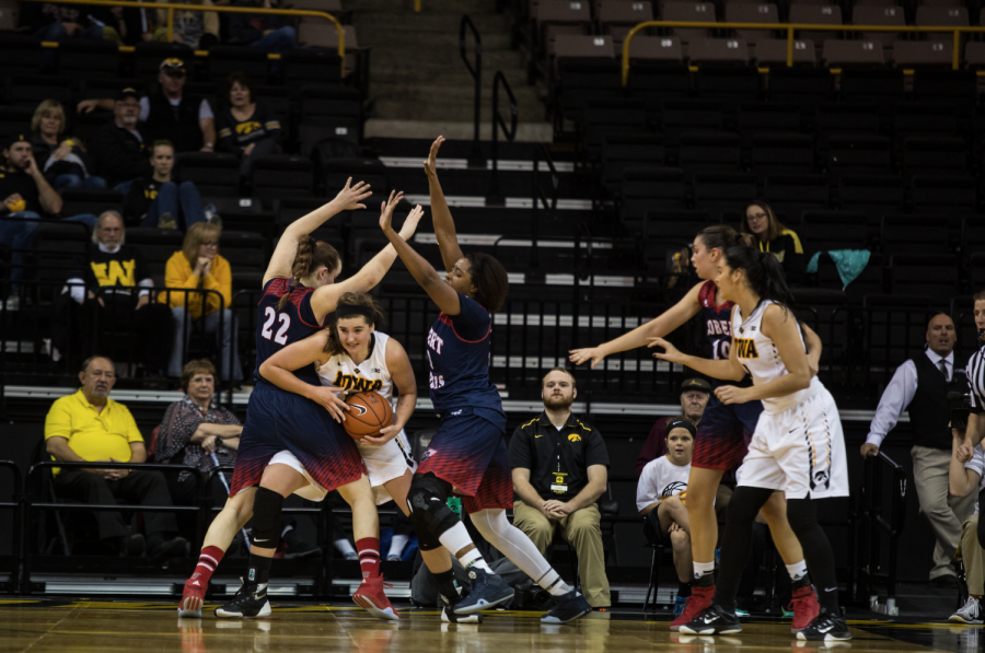 Iowa forward Megan Gustafson fights off Robert Morris forward Megan Smith and Leah Wormack. The Hawkeyes defeated the Colonials 69-50 at Carver-Hawkeye Arena on Dec. 6, 2015.