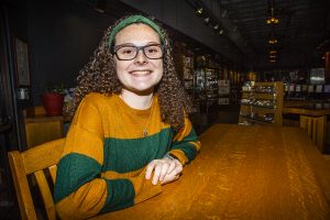 UI junior Ella McDonald poses for a portrait at Java House on Monday, February 11, 2019. McDonald started the Half Caff podcast with coworker Jack Berning about living the life of a barista. (Katina Zentz/The Daily Iowan)