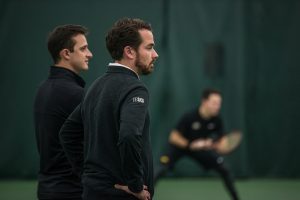 Iowa coach Ross Wilson watches his team during a mens tennis match between Iowa and Marquette on Saturday, January 19, 2019. The Hawkeyes swept the Golden Eagles, 7-0. 