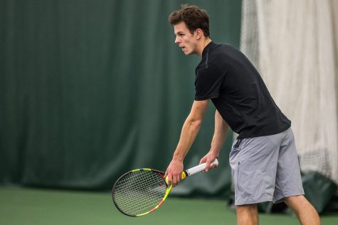 Iowas Piotr Smietana prepares to serve during a mens tennis match between Iowa and East Tennessee State on Friday, January 25, 2019. The Hawkeyes defeated the Buccaneers, 4-3.