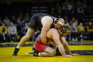 Iowas #3 Sam Stoll wrestles Rutgers Christian Colucci  during the Iowa/Rutgers wrestling meet at Carver-Hawkeye Arena on Friday, January 18, 2019. Stoll defeated Colucci, 4-0. The Hawkeyes defeated the Scarlet Knights, 30-6. 