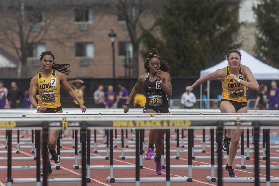 From left: Iowas Tria Seawater-Simmons, Minnesota States Alexis Smith, and Iowas Jenny Kimbro compete in the womens 100 meter hurdles during the 19th annual Musco Twilight meet at the Francis X. Cretzmeyer Track in Iowa City on Thursday, April 12. Kimbro finished first with the time of 13.77. 