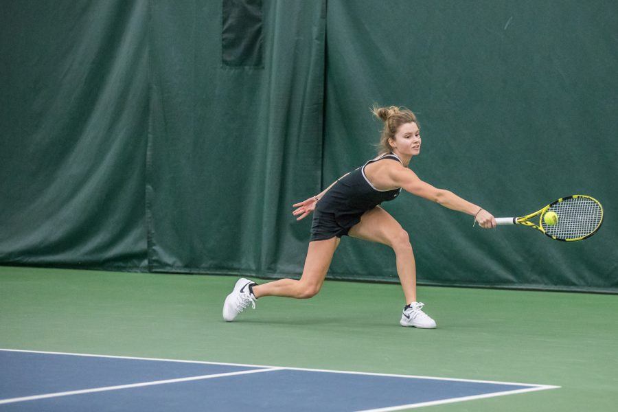 Iowas Cloe Ruette reaches for a backhand during a womens tennis match between Iowa and Penn State at the HTRC on Sunday, February 24, 2019. The Hawkeyes fell to the Nittany Lions, 4-3.