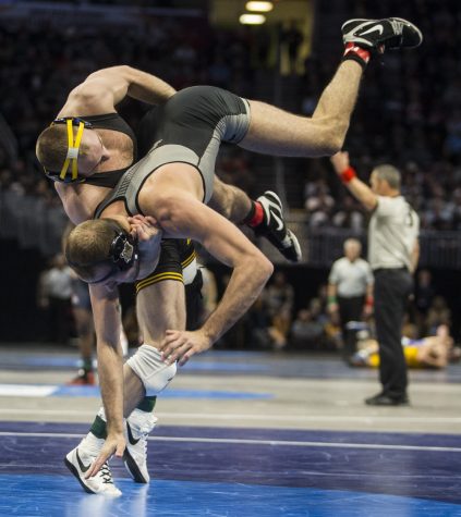 Iowas 165-pound Alex Marinelli takes down Purdues Jacob Morrissey during Session 1 of the NCAA Division 1 Wrestling Championships at Quicken Loans Arena in Cleveland, Ohio on Thursday, March 15, 2018. Marinelli went on to defeat Morrissey by fall in 6:20. Iowa leads the tournament with 18.5 team points at the end of Session 1. 