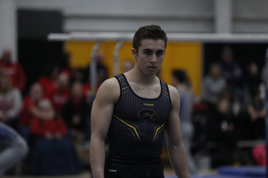 Noah Scigliano prepares to perform on the floor event during the meet against Nebraska at the UI Field House on Saturday, March 2, 2019. Iowa took the victory with a score of 406.500 over Nebraska with a score of 403.550.