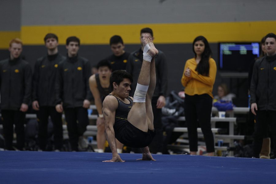 Evan Davis performs on the floor event during the meet against Nebraska at the UI Field House on Saturday, March 2, 2019. Davis took home a season best with a score of 13.700 and assisted Addison Chung in contributing to Iowas season best team score of 68.400. Iowa took the victory with a score of 406.500 over Nebraska with a score of 403.550.