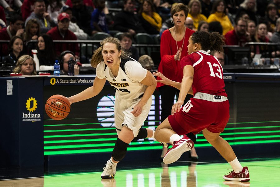 Iowa guard Kathleen Doyle dribbles past Indiana guard Jaelynn Penn during the womens Big Ten tournament basketball game vs. Indiana at Bankers Life Fieldhouse on Friday, March 8, 2019. The Hawkeyes defeated the Hoosiers 70-61. 