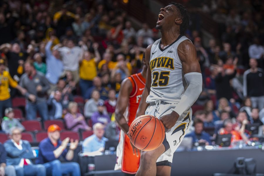 Iowa forward Tyler Cook flexes after dunking during the Iowa/Illinois Big Ten Tournament mens basketball game in the United Center in Chicago on Thursday, March 14, 2019. (Lily Smith/The Daily Iowan)
