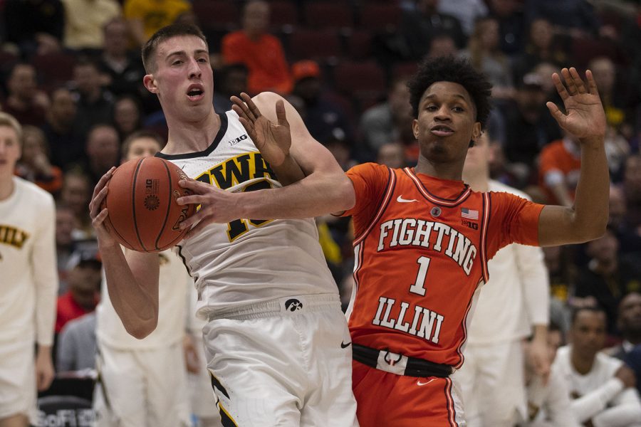 Iowa guard Joe Wieskamp and Illinois guard Trent Frazier fight for control of the ball during the Iowa/Illinois Big Ten Tournament mens basketball game in the United Center in Chicago on Thursday, March 14, 2019. The Hawkeyes defeated the Fighting Illini, 83-62. 