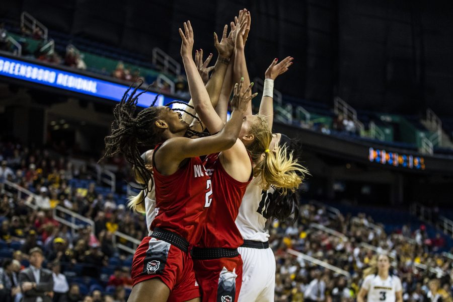 Iowa and NC State players reach for a rebound during the NCAA Sweet 16 game against NC State at the Greensboro Coliseum Complex on Saturday, March 30, 2019. The Hawkeyes defeated the Wolfpack 79-61.