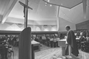 Father Edward Fitzpatrick conducts an evening mass on Sunday at the Newman Catholic Student Center. A UI study recently found a correlation between attending religious services and a longer life expectancy.