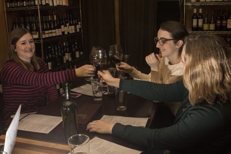 Graduate students (from left) Anna Williams, Laura Hayes and Lydia Maunz sit down for a drink in Brix Cheese Shop and Wine Bar on March 25, 2019. All three began as a reading group and have since continued to lean on each other for support through writing their dissertations. (Katie Goodale/The Daily Iowan)