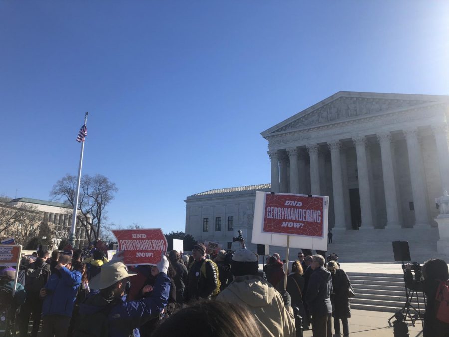 Protesters+stand+in+front+of+the+steps+of+the+Supreme+Court+building+to+call+for+an+end+to+gerrymandering+on+Tuesday%2C+March+26%2C+2019.+The+Supreme+Court+heard+arguments+Tuesday+morning+in+a+case+regarding+partisan+gerrymandering+in+North+Carolina+and+Maryland.