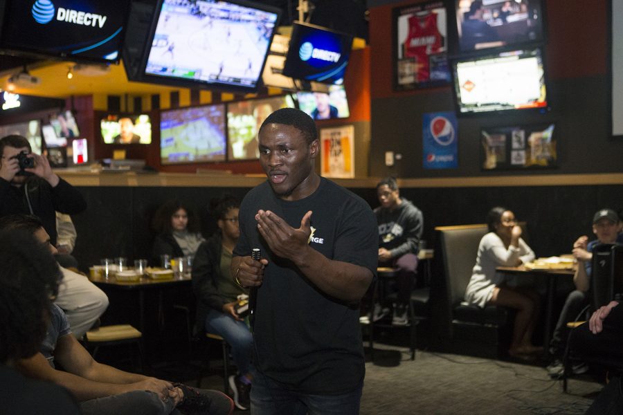 Charge Party student body presidential candidate Dady Mansaray greets voters at Buffalo Wild Wings on March 24. 