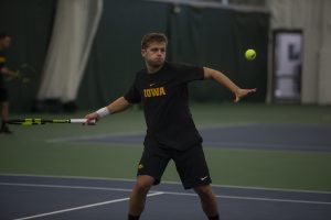 Will Davies hits the ball during the Mens tennis match against University of Miami at the Hawkeye Tennis and Recreation Complex on Feb. 8, 2019. Davies lost his singles match against Miamis William Grattan-Smith. Miami defeated Iowa 4-1. (Katie Goodale/The Daily Iowan)