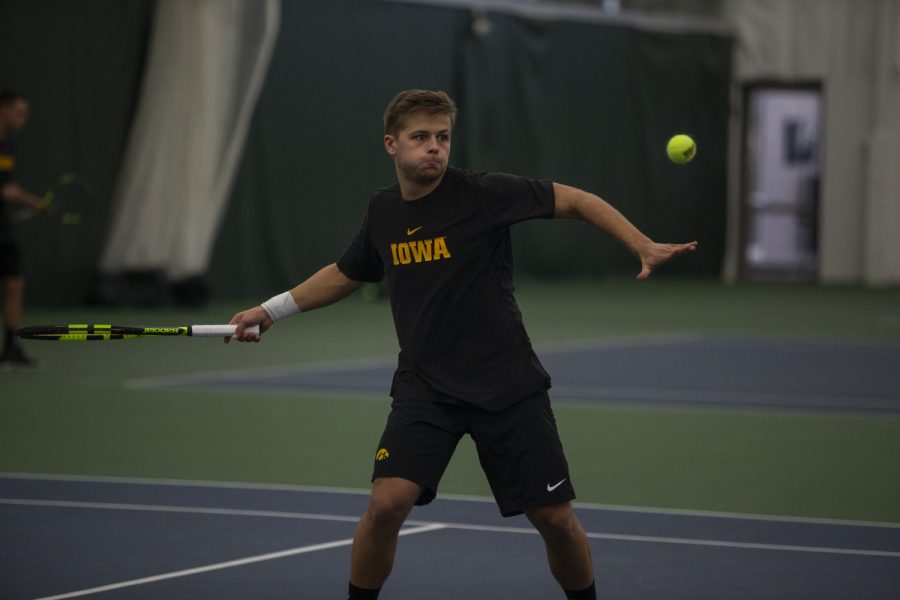 Will Davies hits the ball during the Mens tennis match against University of Miami at the Hawkeye Tennis and Recreation Complex on Feb. 8, 2019. Davies lost his singles match against Miamis William Grattan-Smith. Miami defeated Iowa 4-1. (Katie Goodale/The Daily Iowan)