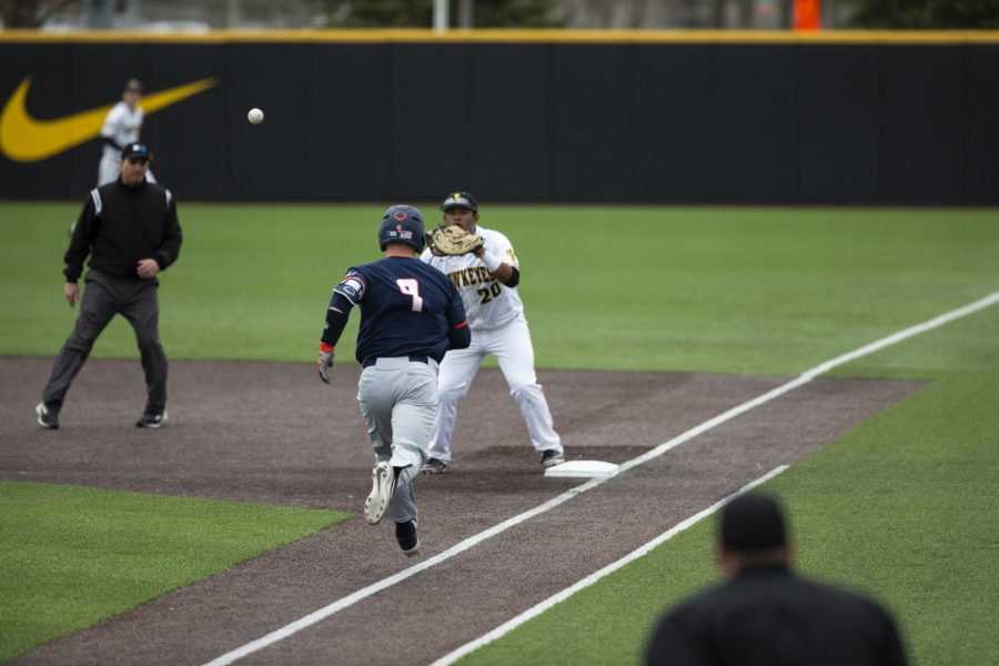 Iowa first baseman Izaya Fullard catches the ball thrown by catcher Mitchell Boe to tag out Illinois catcher Jacob Cambell. The Hawkeyes defeated the Illini 8-4 at Duane Banks Field on Mar 29, 2019.