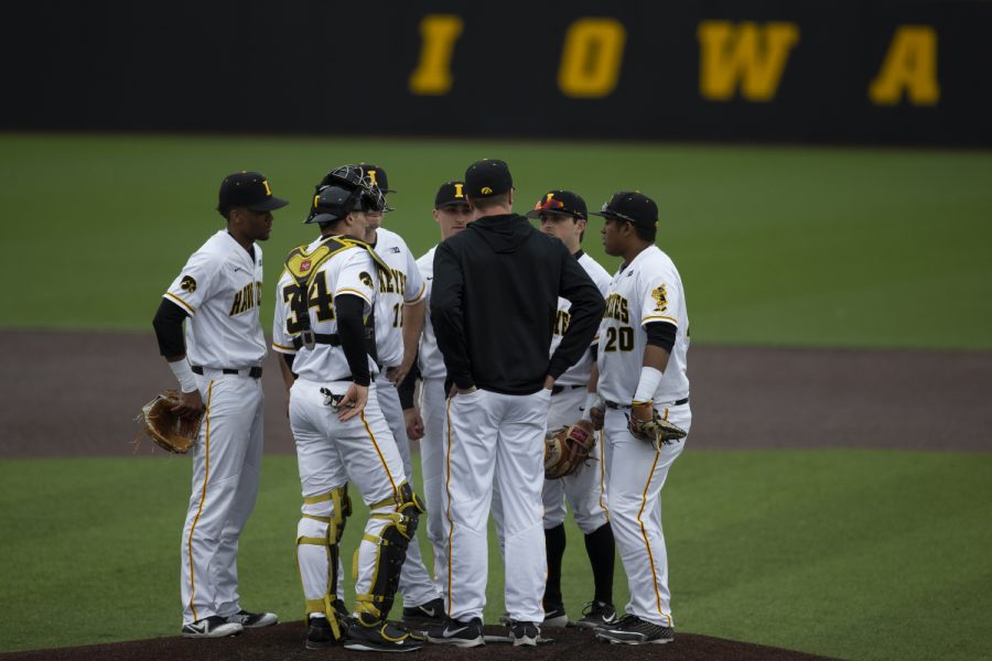 The Iowa infield meets on the mound during a game. The Hawkeyes defeated the Illini 8-4 at Duane Banks Field on Mar 29, 2019. 
