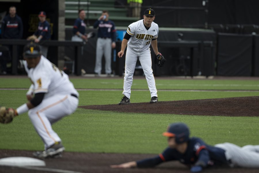Iowa pitcher Cole McDonald watches to see if Izaya Fullard will make the play at first base. The Hawkeyes defeated the Illini 8-4 at Duane Banks Field on Mar 29, 2019. 