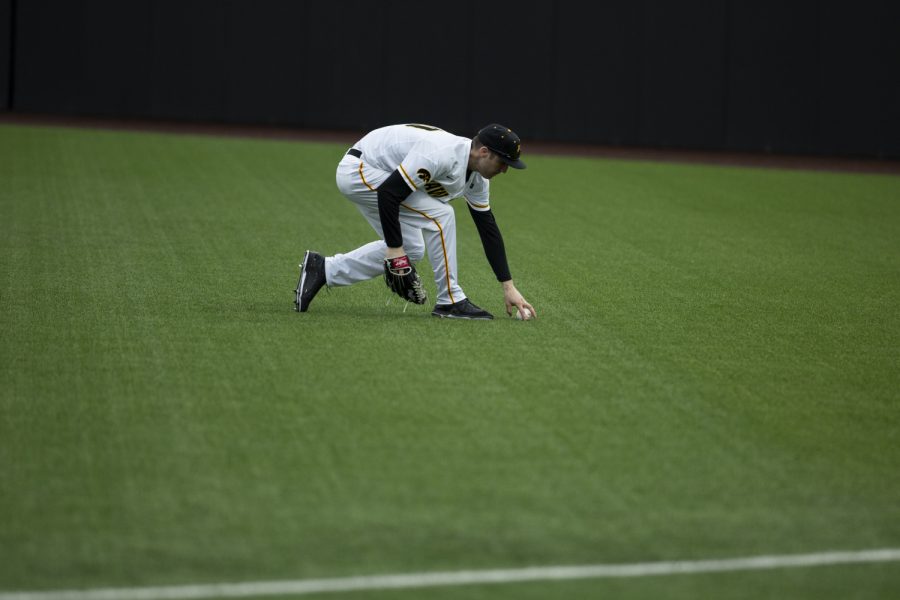 Iowa right fielder Connor McCaffery returns the ball he dropped during a game against the Illini. The Hawkeyes defeated the Illini 8-4 at Duane Banks Field on Mar 29, 2019. 