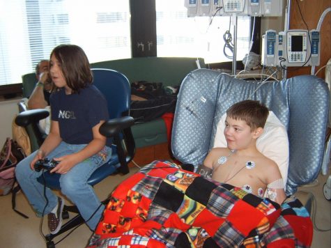 Bryce and Brooklyn Draisey play video games on a PlayStation 2. Bryce often played video games at home, so it was one of his favorite pastimes while he was in the hospital.