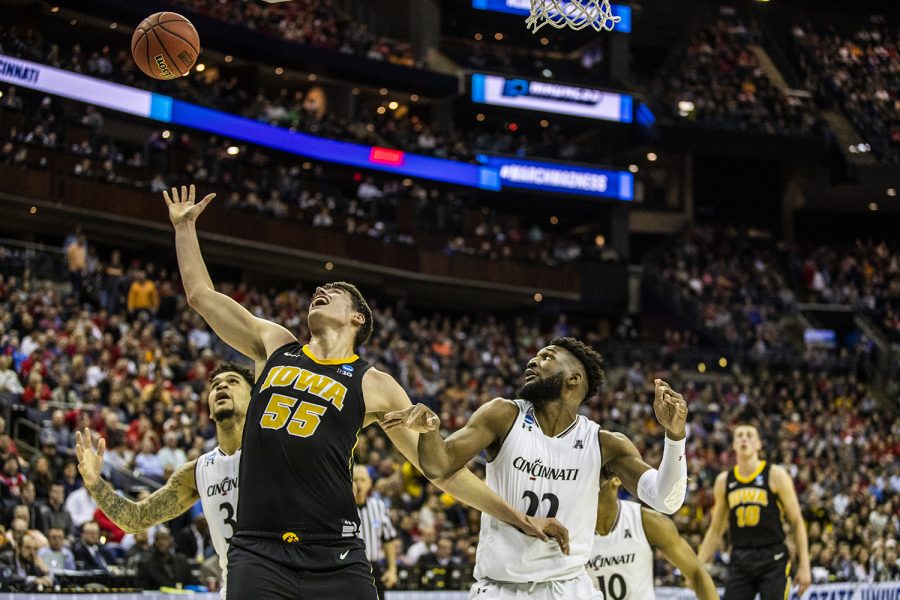 Iowa+guard+Luka+Garza+reaches+for+the+ball+during+the+NCAA+game+against+Cincinnati+at+Nationwide+Arena+on+Friday%2C+March+22%2C+2019.+The+Hawkeyes+defeated+the+Bearcats+79-72.