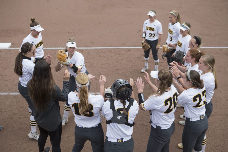 Iowa pitcher Sydney Owens high fives teammates during starting lineups of the conference opening softball game at Pearl Field on Friday, March 29, 2019. Doocy pitched the entire game, despite an injury during the fourth inning. The Wildcats defeated the Hawkeyes 5-1. 