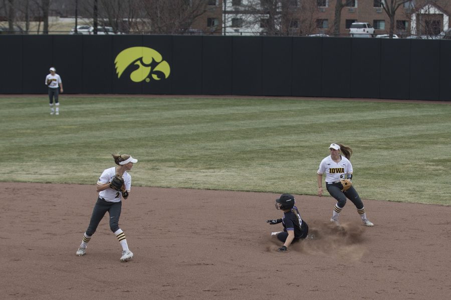 Northwestern infielder Skyler Shellmyer slides into second during the conference opening softball game at Pearl Field on Friday, March 29, 2019. The Wildcats defeated the Hawkeyes 5-1. 