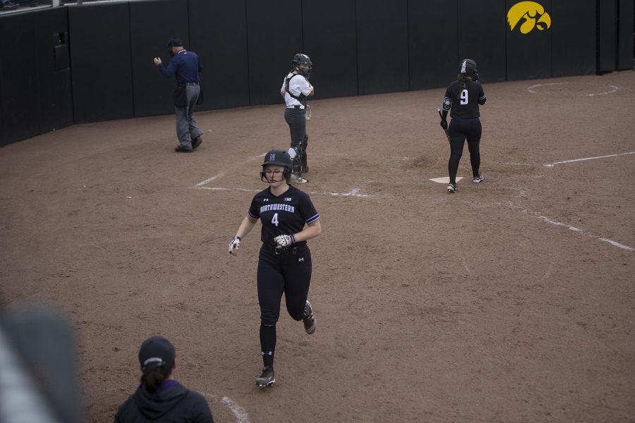 Northwestern infielder Maeve Nelson jogs back to the dugout after scoring one of four runs during the seventh inning of the conference opening softball game at Pearl Field on Friday, March 29, 2019. The Wildcats scored four runs during the top of the seventh inning, and the Hawkeyes were unable to match it. The Wildcats defeated the Hawkeyes 5-1. 