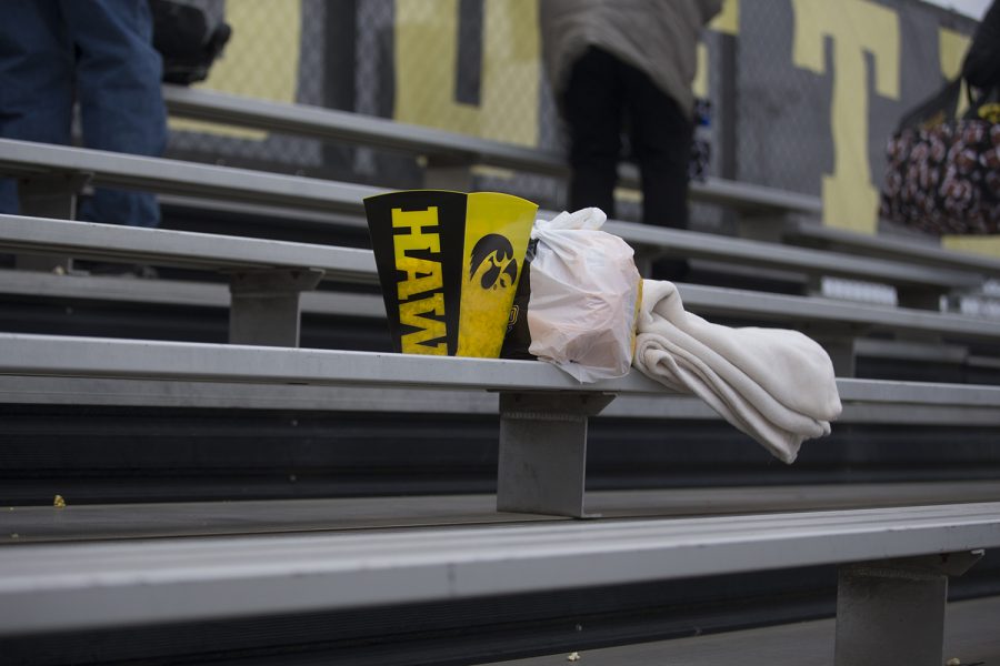 Personal items sit unattended in the bleachers following the conference opening softball game at Pearl Field on Friday, March 29, 2019. The Wildcats defeated the Hawkeyes 5-1. 