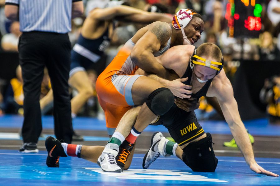 Iowa’s 165-pound Alex Marinelli wrestles Virginia Tech’s Mekhi Lewis during the third session of the 2019 NCAA D1 Wrestling Championships at PPG Paints Arena in Pittsburgh, PA on Friday, March 22, 2019. Lewis won by decision, 3-1.