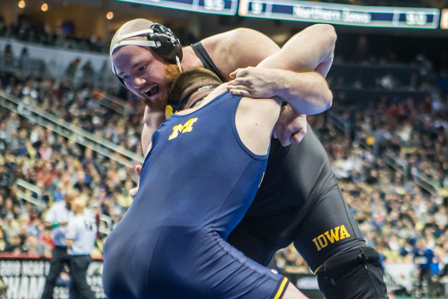 Iowa’s 285-pound Sam Stoll wrestles Michigan’s Mason Parris during the first session of the 2019 NCAA D1 Wrestling Championships at PPG Arena in Pittsburgh, PA on Thursday, March 21, 2019. Stoll won by decision, 8-5.