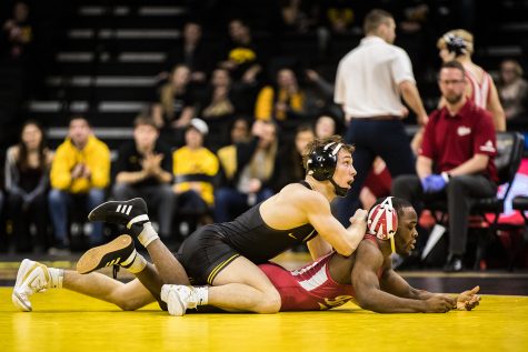 Iowas No. 2 Spencer Lee wrestles Indianas Elijah Oliver at 125lb during a wrestling match between Iowa and Indiana at Carver-Hawkeye Arena on Friday, February 15, 2019. The Hawkeyes, celebrating senior night, defeated the Hoosiers 37-9. (Shivansh Ahuja/The Daily Iowan)