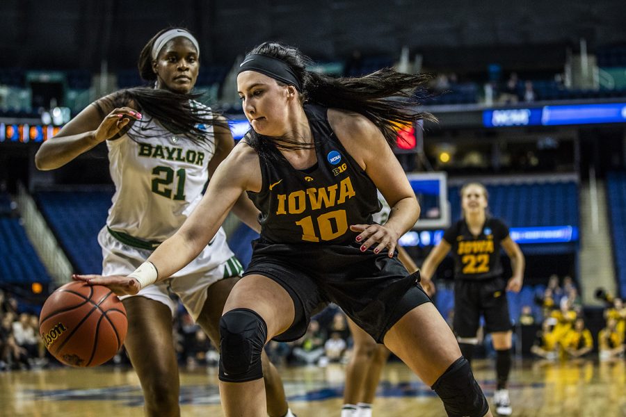 Iowa+center+Megan+Gustafson+takes+a+hold+of+the+ball+as+Baylor+center+Kalani+Brown+runs+to+guard+her+during+the+NCAA+Elite+8+game+against+Baylor+on+April+1.