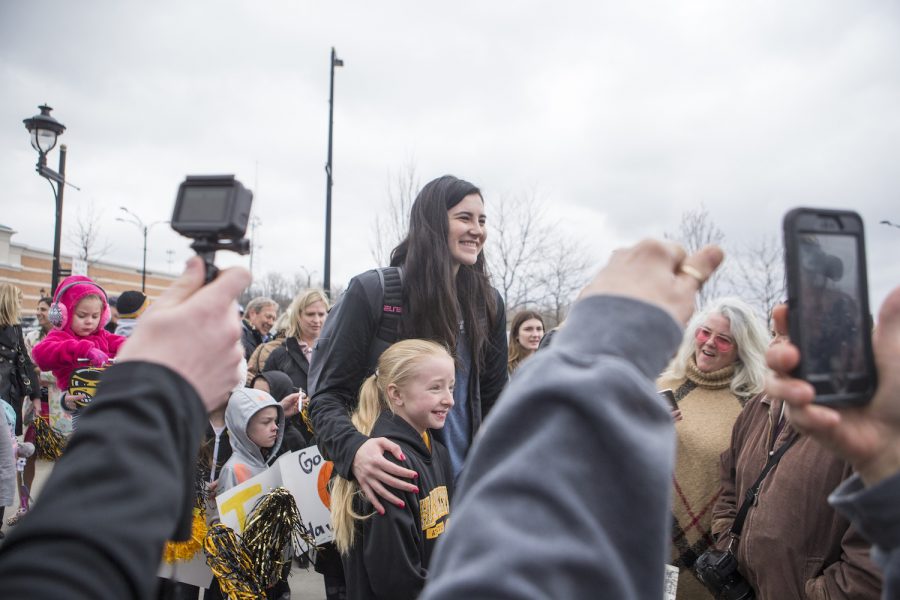 Megan Gustafson takes a photo with a young fan on April 2, 2019. 