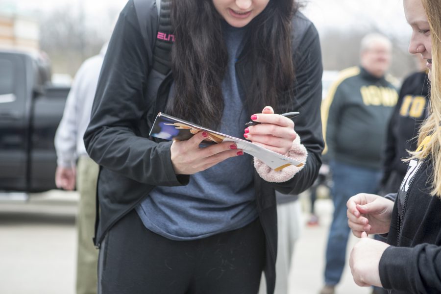 Megan Gustafson signs an autograph for a fan on April 2, 2019. 