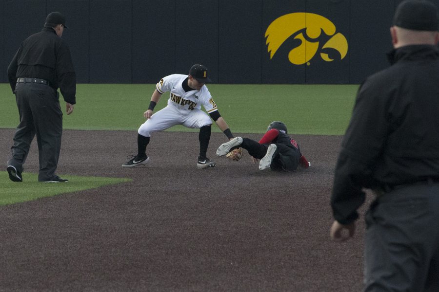 Iowa infielder Mitchell Boe tries to tag a runner out at second at the Iowa vs Rutgers game at Duane Banks Field on Friday, April 4, 2019. The Hawkeyes defeated the Scarlet Knights 6-1.