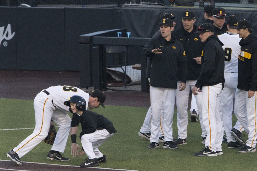 Iowa's Chris Whelan high fives the ball boy at the Iowa vs Rutgers game at Duane Banks Field on Friday, April 4, 2019. The Hawkeyes defeated the Scarlet Knights 6-1.