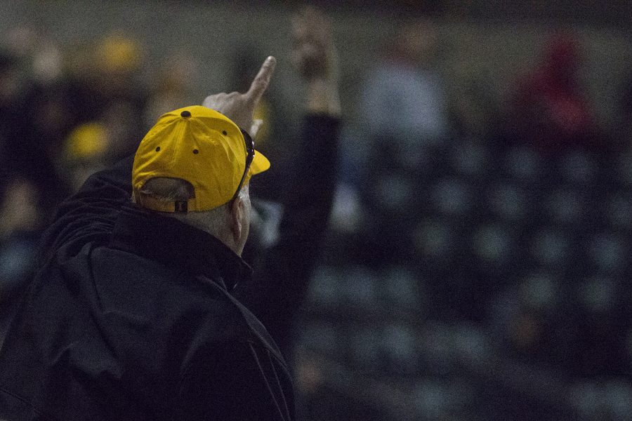 An Iowa fan raises his hand in hopes of catching a tee shirt at the Iowa vs Rutgers game at Duane Banks Field on Friday, April 4, 2019. The Hawkeyes defeated the Scarlet Knights 6-1.