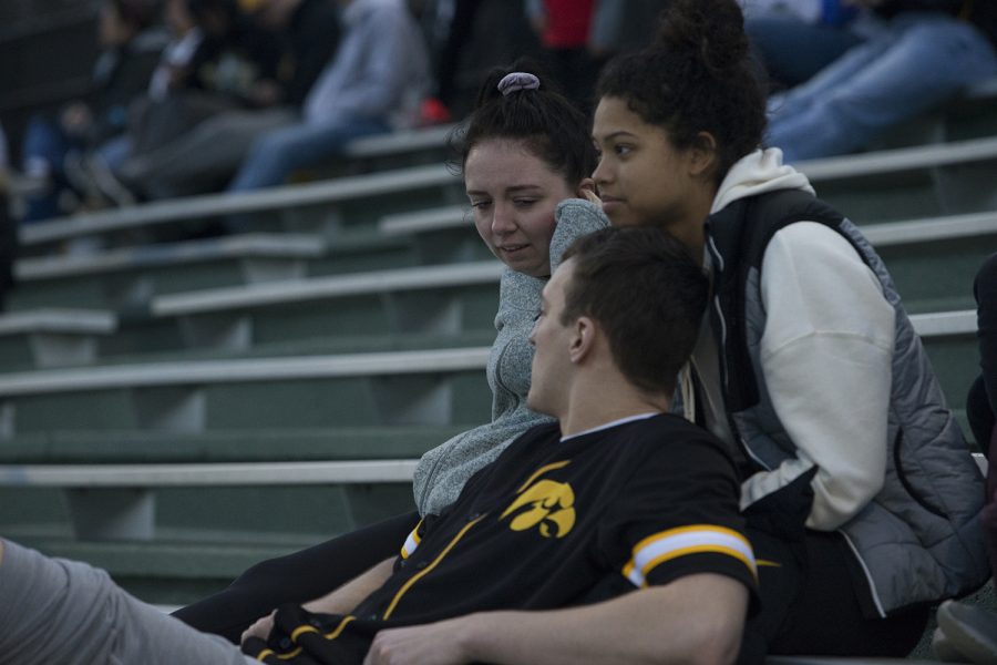 Spectators watch the game and talk at the Iowa vs Rutgers game at Duane Banks Field on Friday, April 4, 2019. The Hawkeyes defeated the Scarlet Knights 6-1.