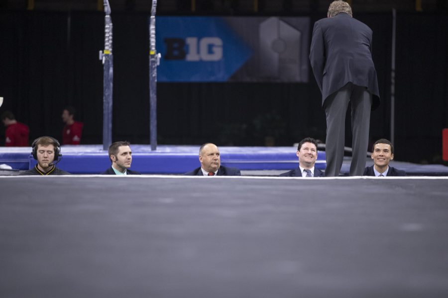 Officials talk before competition begins Friday in Carver Hawkeye Arena during the Men's Big Ten Championships. Penn State won the team competition with a combined score of 410.350 points.