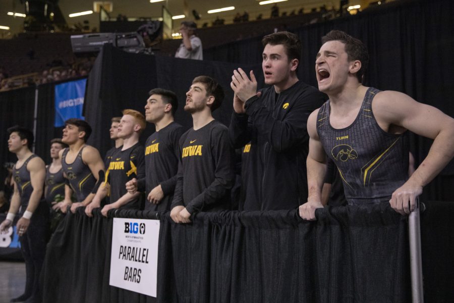 Hawkeye gymnasts cheer on a teammate Friday in Carver Hawkeye Arena during the Men's Big Ten Championships. Penn State won the team competition with a combined score of 410.350 points. 