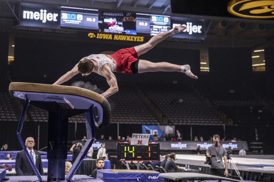 Nebraska gymnast Jonathan Scripnick vaults Friday in Carver Hawkeye Arena during the Men's Big Ten Championships. Penn State won the team competition with a combined score of 410.350 points. 