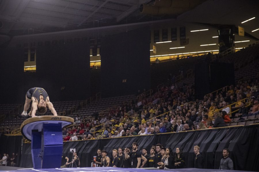 Hawkeye gymnast Mitch Mandozzi competes in the vault Friday in Carver Hawkeye Arena during the Men's Big Ten Championships. Penn State won the team competition with a combined score of 410.350 points. 