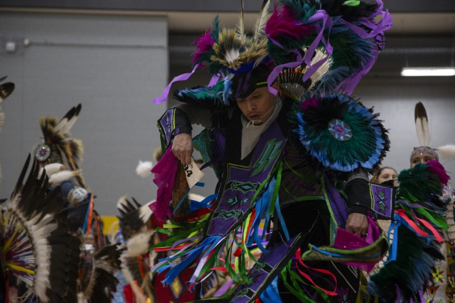 Dancers perform in the grand entrance during the 25th annual University of Iowa Powwow in the Fieldhouse on April 20, 2019. Hosted by the Native American Student Association, participants could buy traditional food and clothing, and sign up to perform traditional song and dance.