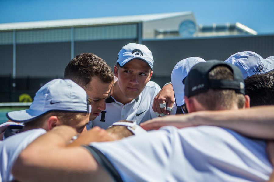 Iowa players huddle before a men's tennis match between Iowa and Michigan at the HTRC on Sunday, April 21, 2019. The Hawkeyes, celebrating senior day, defeated the Wolverines, 4-1.