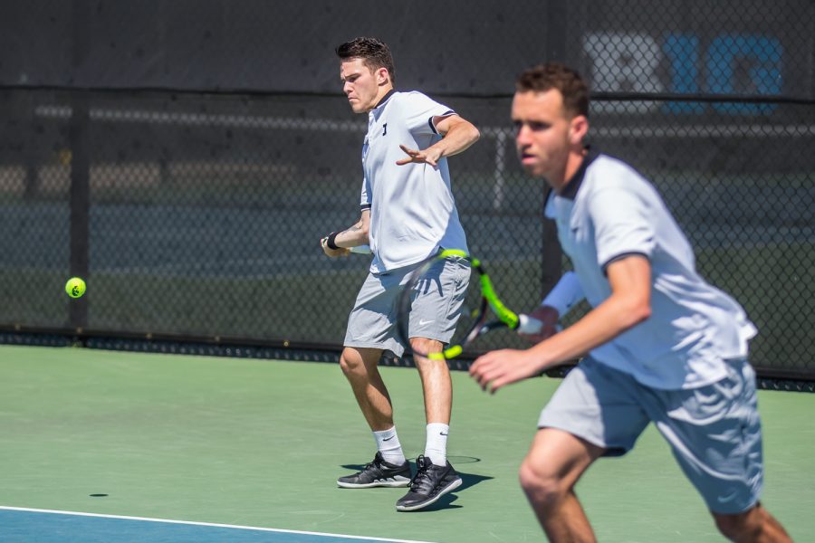 Iowa's Jonas Larsen hits a forehand during a men's tennis match between Iowa and Michigan at the HTRC on Sunday, April 21, 2019. The Hawkeyes, celebrating senior day, defeated the Wolverines, 4-1.